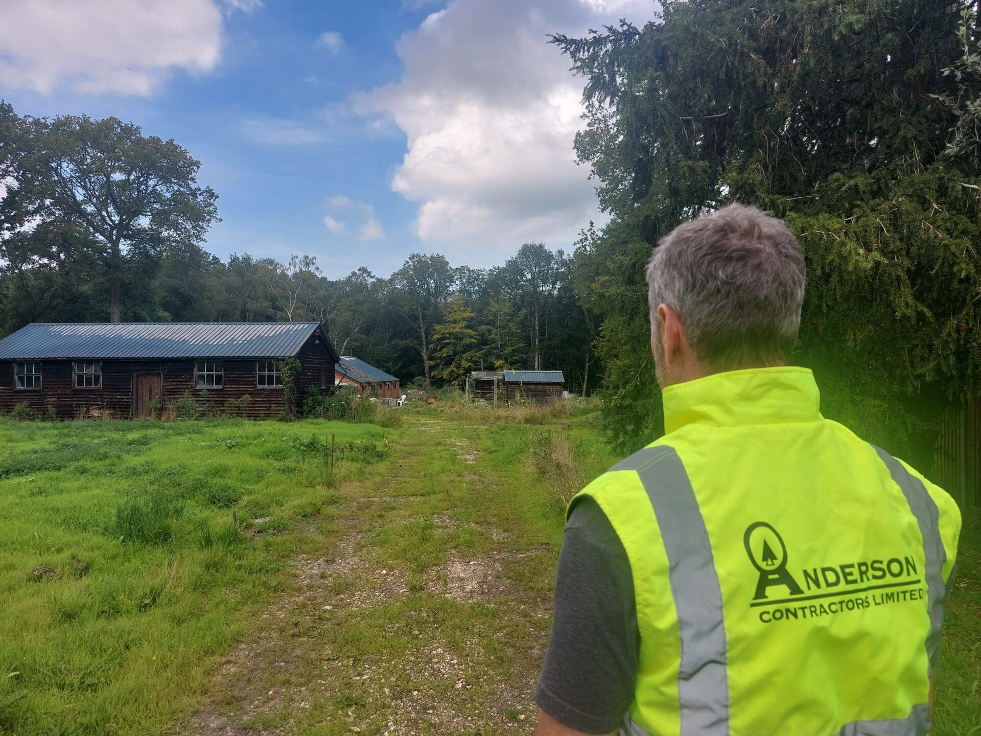 Image of Geoff Anderson wearing a hi vis vest on a brownfield site